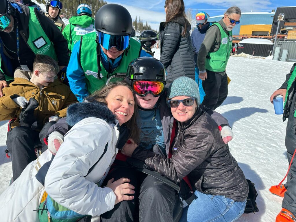 Catherine, Sarah with Henry sit ski